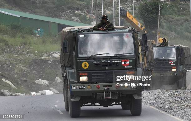 Indian army soldiers on top of a military vehicle crossing the Srinagar-Leh National highway on September 01, 2020.In a further escalation of...