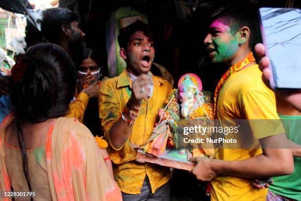 Hindu devotees celebrate as they take idol of Lord Ganesh to an artificial pond to perform Visarjan on the occasion of Anant Chaturthi on September...