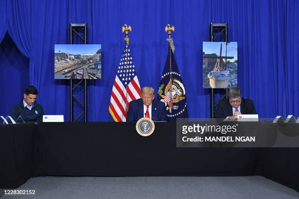 President Donald Trump with US Attorney General William Barr and Acting Homeland Security Secretary Chad Wolf , bows his head in prayer during a...