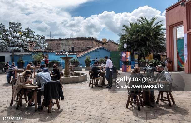 People wear face mask during a pilot test of restaurant opening in Chorro de Quevedo tourist area, in Bogota on September 1 during te coronavirus...