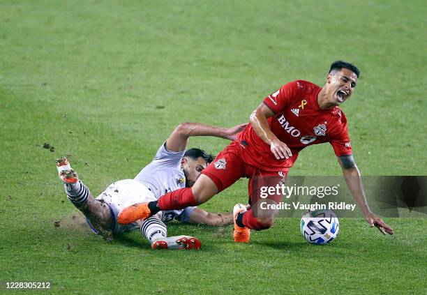 Erickson Gallardo of Toronto FC is tackled by Saphir Taïder of Montreal Impact during the second half of an MLS game at BMO Field on September 01,...