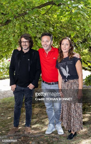 In this photograph taken on September 1 : French director Thomas Bornot, French director Cyril Montana and French distributor Jane Roger pose during...