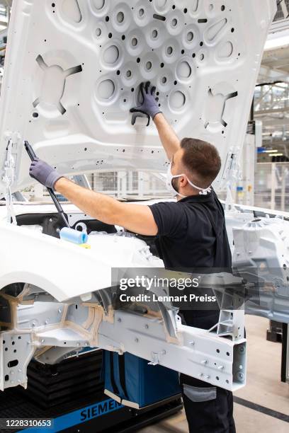 Workers assemble the new S-Class Mercedes-Benz passenger car at the new "Factory 56" assembly line at the Mercedes-Benz manufacturing plant on...