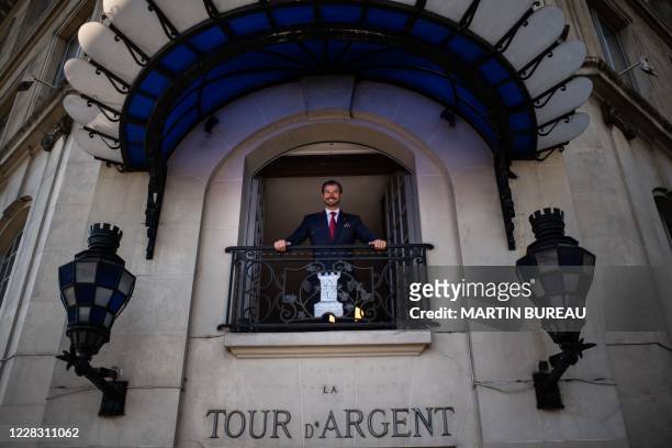 Paris restaurant La Tour d'Argent's director Andre Terrail poses from a restaurant's window in central Paris on September 2, 2020.