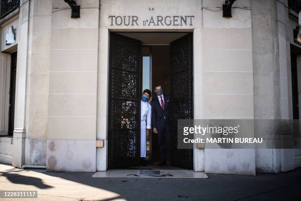 Paris restaurant La Tour d'Argent's French chef Yannick Franques and director Andre Terrail pose at the restaurant's entrance in central Paris on...