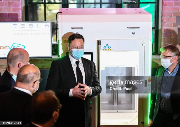 Tesla and SpaceX CEO Elon Musk presents a vaccine production device next to Christian Democratic Union and Christian Social Union faction leader in...