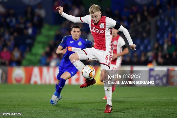 In this file photo taken on February 20, 2020 Ajax's Dutch midfielder Donny Van de Beek controls the ball the Europa League round of 32 football...