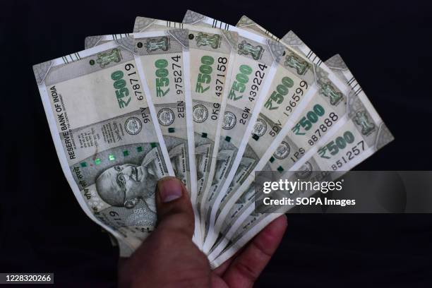 In this photo illustration five hundred Indian rupee notes.