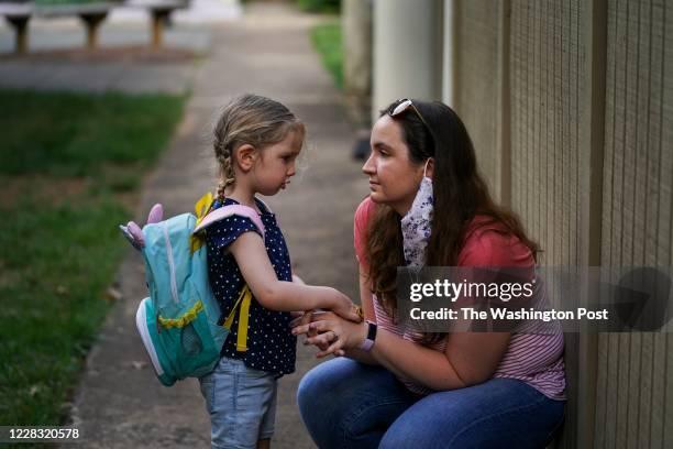 Sarah McClusky, R, consoles her 4-year-old daughter, Beatrice, at their home in Reston, VA, on Thursday, August 27, 2020. Sara McClusky and her...