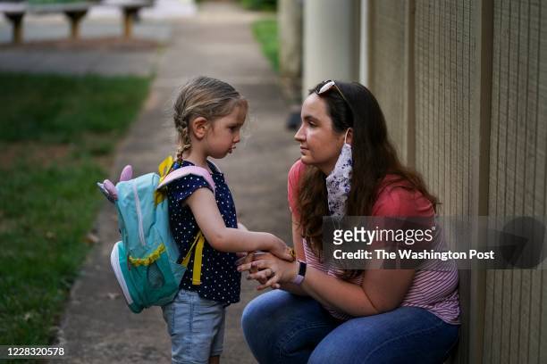 Sarah McClusky, R, consoles her 4-year-old daughter, Beatrice, at their home in Reston, VA, on Thursday, August 27, 2020. Sara McClusky and her...