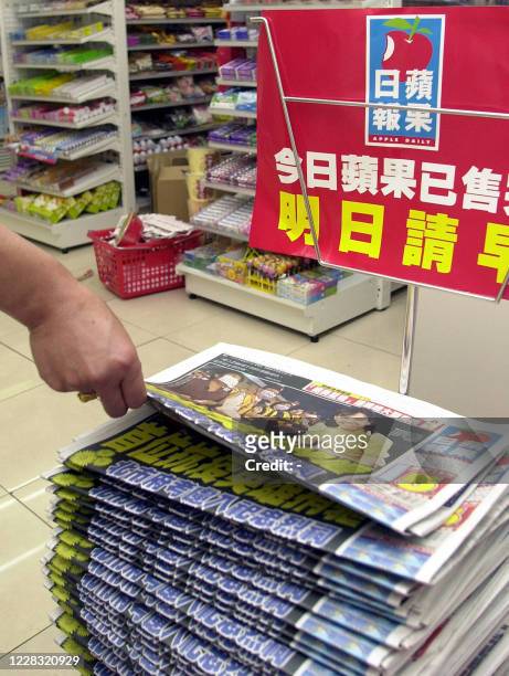 Customer picks up Apple Daily newspaper at a local store in Taipei, 02 May 2003. Hong Kong media tycoon Jimmy Lai is to launch a Taiwanese edition of...