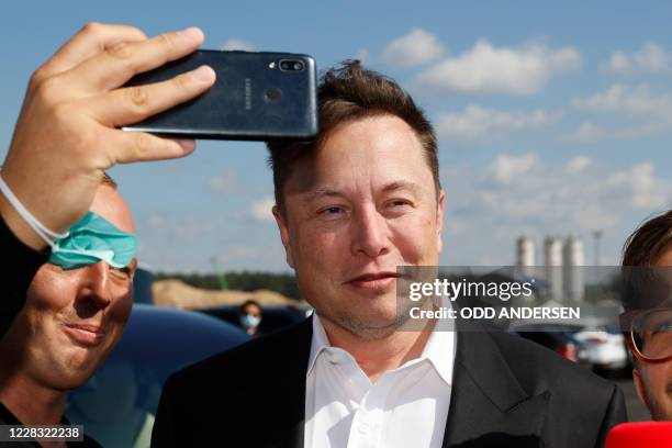 Tesla CEO Elon Musk poses for selfies with Tesla fans and media as arrives to visit the construction site of the future US electric car giant Tesla,...