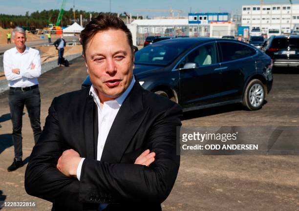 Tesla CEO Elon Musk talks to media as he arrives to visit the construction site of the future US electric car giant Tesla, on September 03, 2020 in...