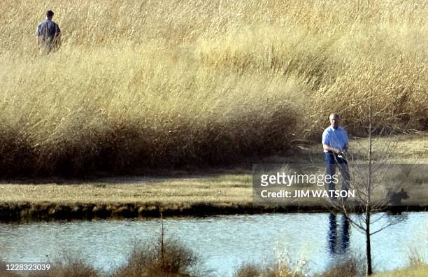 President George W. Bush fishes on a pond on his property as he awaits Danish Prime Minister Anders Fogh Rasmussen arrival to Prarie Chapel Ranch in...