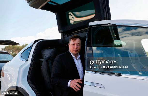 Tesla CEO Elon Musk gets back into his Tesla after talking to media before visiting the construction site of the future US electric car giant Tesla,...