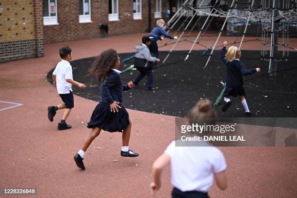 Students play during their break on their first day of school after the summer break at St Luke's Church of England Primary School in East London on...