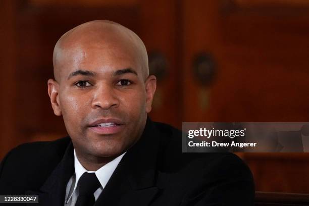 Surgeon General Jerome Adams attends an event to mark National Alcohol and Drug Addiction Recovery Month in the East Room of the White House on...