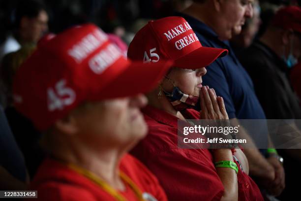 Trump supporters pray as they await the arrival of President Donald Trump at Latrobe Airport on September 3, 2020 in Latrobe, Pennsylvania. President...