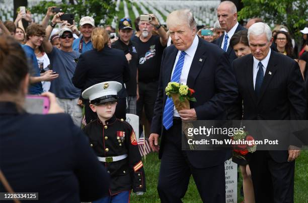 May 29: Christian Jacobs left, walks with President Donald Trump as Vice President Mike Pence is seen at right as they visit in observance of...