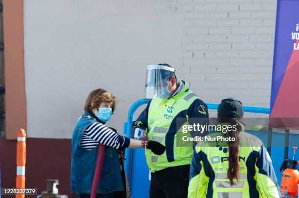 People sanitize their hands and their temperature is taken at el Chorro de Quevedo as part of the pilot to re open restaurants, Bogota, Open Sky...