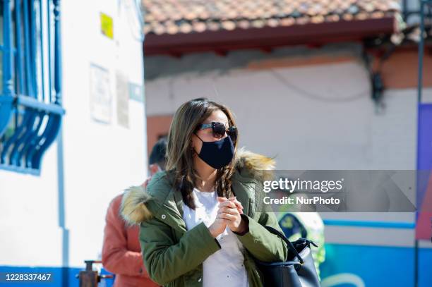 People sanitize their hands and their temperature is taken at el Chorro de Quevedo as part of the pilot to re open restaurants, Bogota, Open Sky...