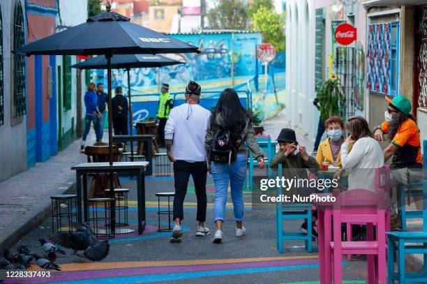 People enjoy a sunny day eating lunch at el Chorro de Quevedo as part of the pilot to re open restaurants, Bogota, Open Sky 'Bogota Cielo Abierto' as...