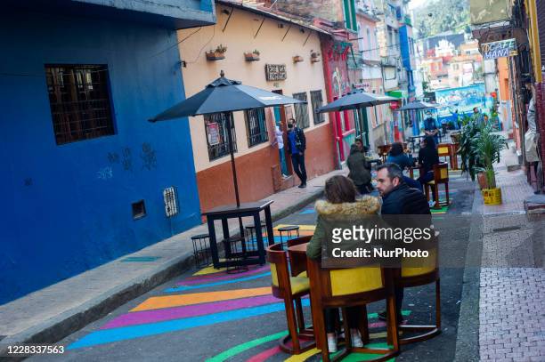 People enjoy a sunny day eating lunch at el Chorro de Quevedo as part of the pilot to re open restaurants, Bogota, Open Sky 'Bogota Cielo Abierto' as...