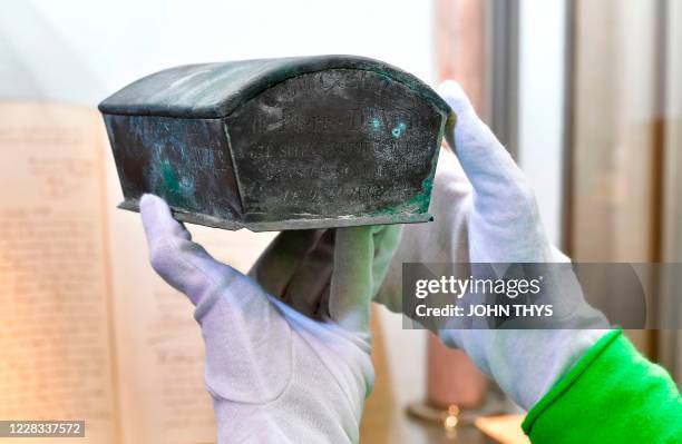 The small zinc casket is held up for display at the city's Museum of Fine Arts on September 03, 2020 in Vervier. - An ornate fountain in Verviers,...