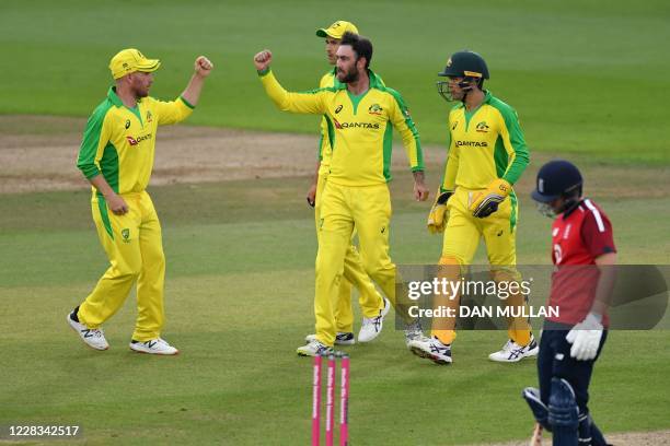Australia's bowler Glenn Maxwell celebrates with Australia's Aaron Finch after taking the wicket of England's batsman Moeen Ali during the...