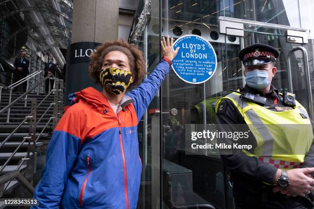 Blue plaque which talks of links to slavery and fossil fuel projects is pasted up outside the Lloyd's of London building on the Walk of Shame...