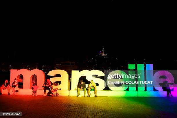 Picture taken on September 4, 2020 shows the illumination of the Marseille logo on the Vieux-Port harbour in Marseille, on the eve of the Gay Pride...