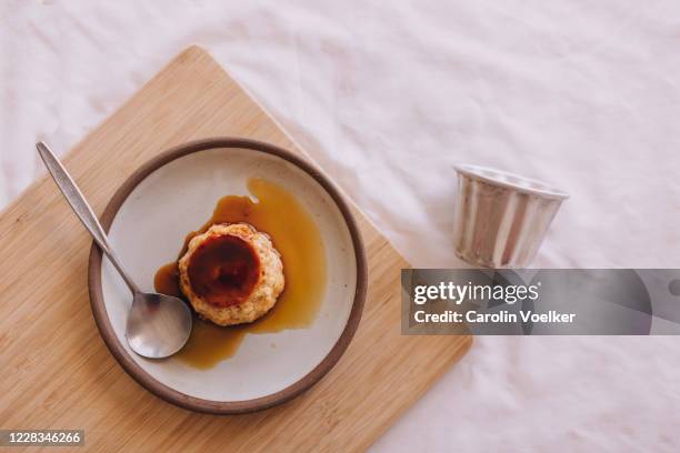 caramel flan on a small plate from above - プリン ストックフォトと画像