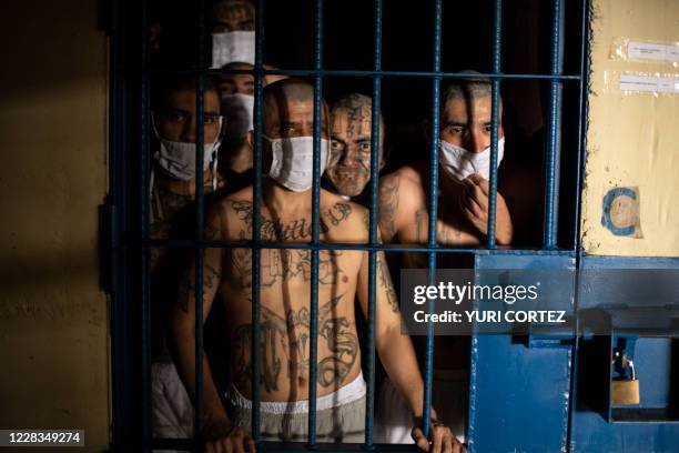 Members of the MS-13 and 18 gangs remain inside their cells during a visit by the Director of the General Directorate of Penal Centers, Osiris Luna ,...