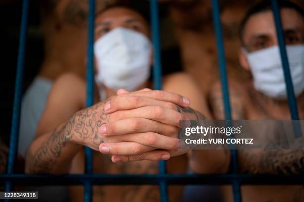 Members of the MS-13 and 18 gangs remain in an overcrowded cell at the Quezaltepeque prison, in Quezaltepeque, El Salvador, on September 4, 2020....