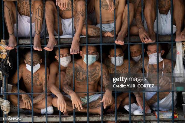 Members of the MS-13 and 18 gangs remain in an overcrowded cell at the Quezaltepeque prison, in Quezaltepeque, El Salvador, on September 4, 2020....