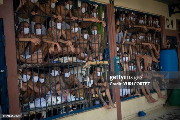 Members of the MS-13 and 18 gangs remain in an overcrowded cell at the Quezaltepeque prison, in Quezaltepeque, El Salvador, on September 4, 2020....