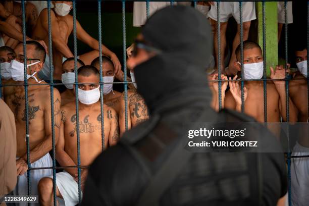 Members of the MS-13 and 18 gangs remain in an overcrowded cell as a security guard of the Director of the General Directorate of Penal Centers,...