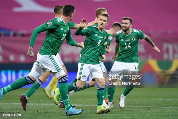 Gavine Whyte and Steven Davis of Northern Ireland celebrate during the game UEFA Nations League 2021 match between Romania and Northern Ireland at...