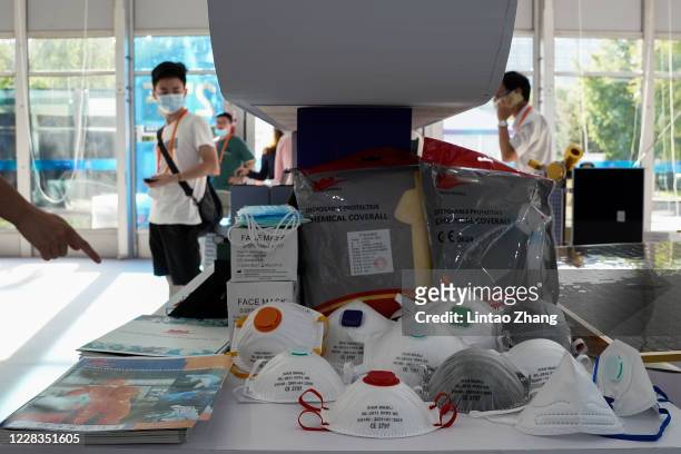 Exhibitors show protective masks during the 2020 China International Fair for Trade in Services at Beijing Olympic Park on September 5, 2020 in...