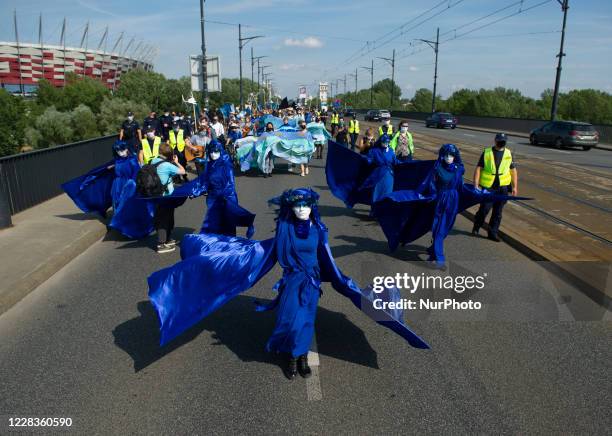 Extinction Rebellion activists dressed in blue gowns take part in the &quot;wave of sadnesses&quot; during the great march for climate change on...