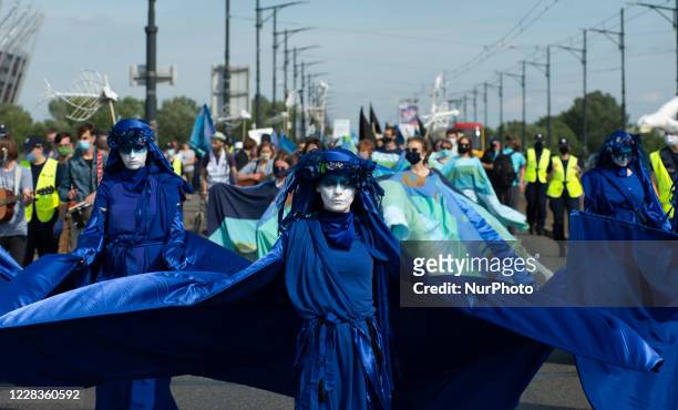 Extinction Rebellion activists dressed in blue gown are seen ahead of the great march for climate on September 5, 2020 in Warsaw, Poland. A few...