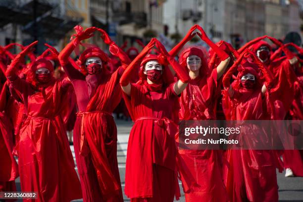 Red Rebel Brigade activists gesture during the great march for climate on September 5, 2020 in Warsaw, Poland. A few thousand people took the streets...