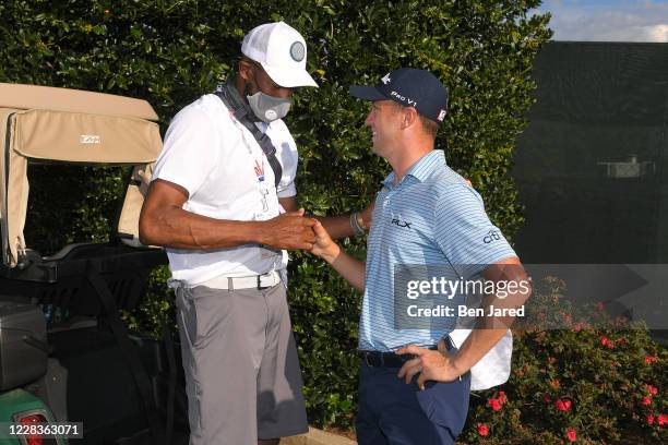 Vince Carter shakes hands with Justin Thomas during the second round of the TOUR Championship at East Lake Golf Club on September 5, 2020 in Atlanta,...