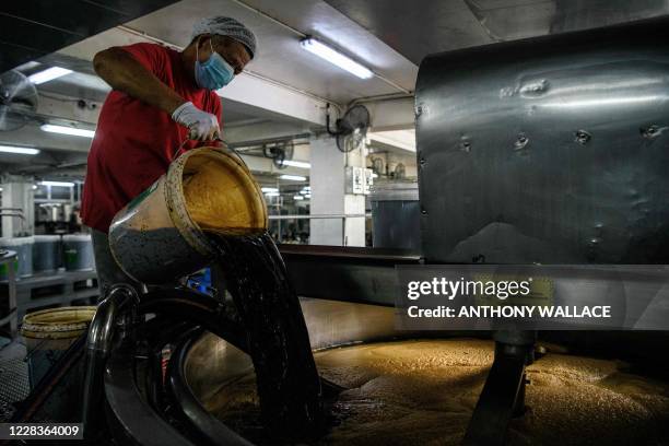 In this picture taken on August 27 an employee works at the Koon Chun Sauce Factory in Hong Kong, which produces soy, hoisin and oyster sauces found...