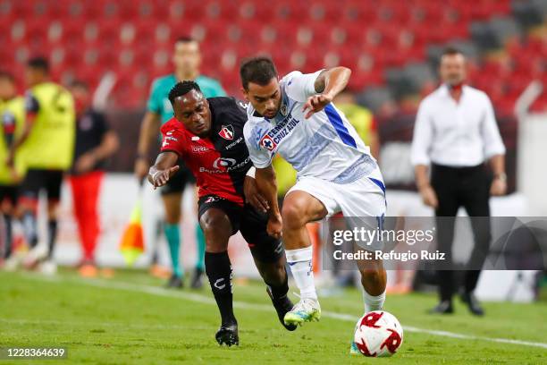 Alex Ibarra of Atlas fights for the ball with Adrian Aldrete of Cruz Azul during the 8th round match between Atlas and Cruz Azul as part of the...