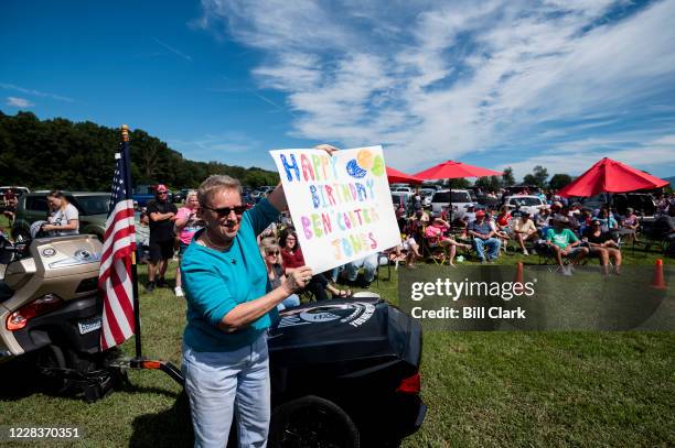 Fan holds a happy birthdasy sign as former Rep. Ben Cooter Jones performs with Cooters Garage Band during his birthday celebration at Cooters Place...
