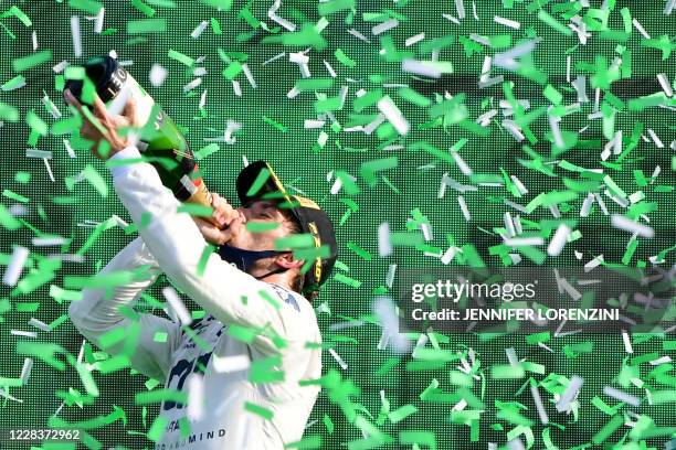 Winner AlphaTauri's French driver Pierre Gasly drinks champagne on the podium after the Italian Formula One Grand Prix at the Autodromo Nazionale...