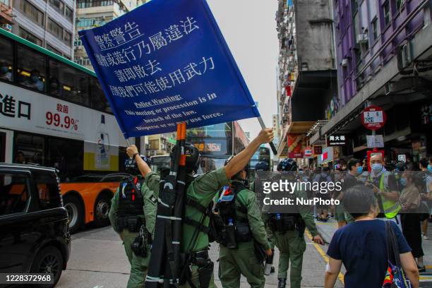 Police raise the blue flag for protesters to disperse during street demonstrations, Jordan, Hong Kong, 6th September 2020