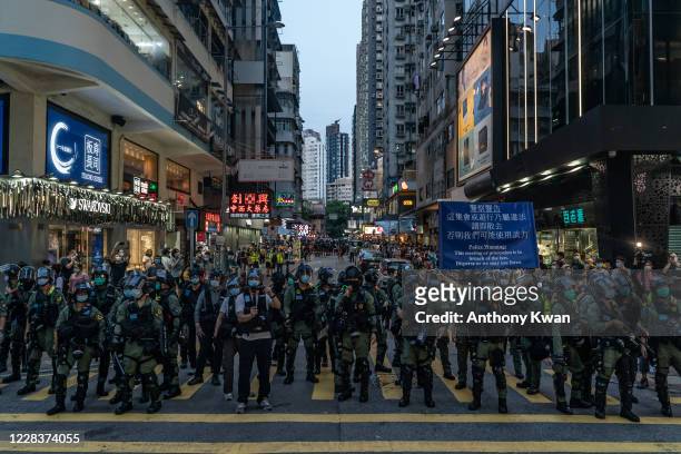 Riot police put up an warning flag during an anti-government protest on September 6, 2020 in Hong Kong, China. Nearly 300 people were arrested during...