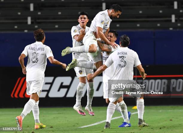 Sebastian Lletget leaps into the arms of Cristian Pavon as Joe Corona, Jonathan dos Santos and Emiliano Insua of the Los Angeles Galaxy join in to...